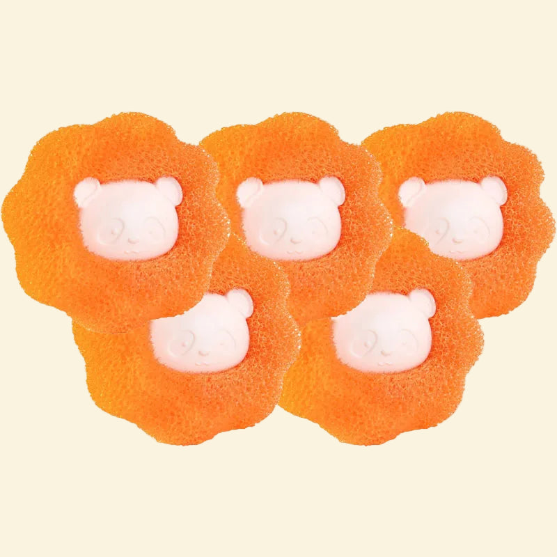 Four orange lion-shaped bath bombs with white faces on a white background