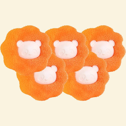 Four orange lion-shaped bath bombs with white faces on a white background